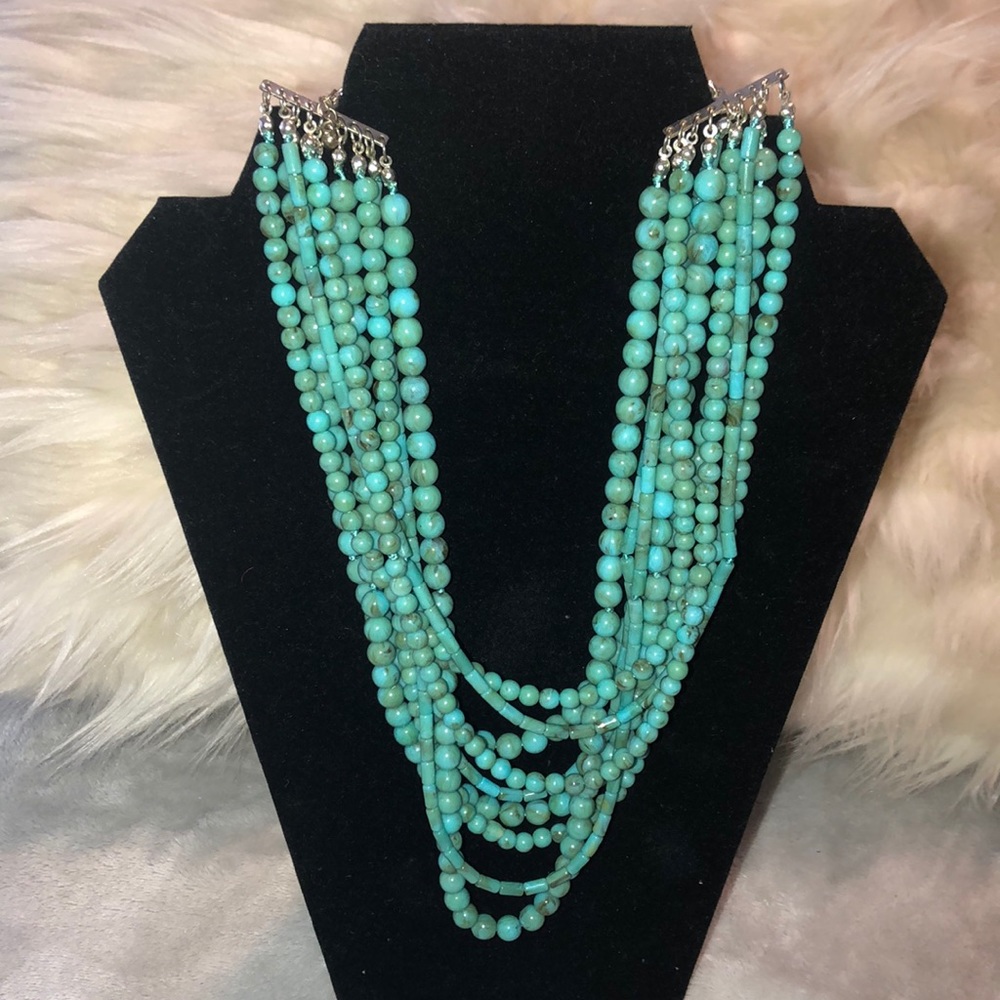“Acapulco” is the name of this beautiful turquoise 9 strand beaded necklace.